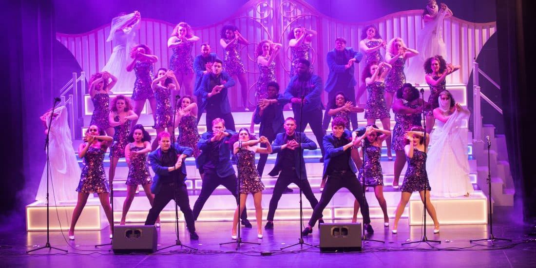 ר Show choir performing on stage during a show.