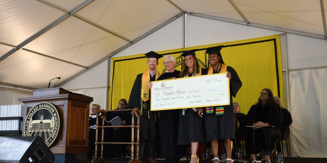 President Lindgren with ר graduates holding a big check.