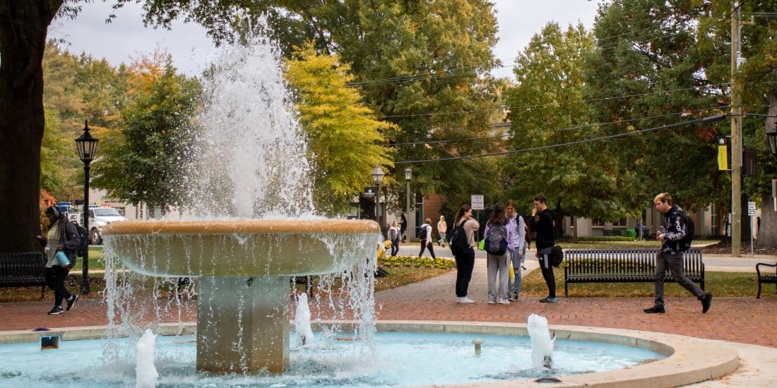 A fountain located in a brick-enclosed walkway welcomes visitors the RMC campus.